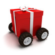 Red gift box with white ribbon on wheels Red gift box with white ribbon on wheels