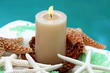 Candle and spa item on white towel