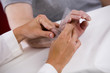 physical therapist uses a goiniometer to test range of motion