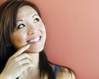 Adorable young woman smiling and looking towards copy space area