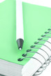 green covered metal ring binder notebook and pen