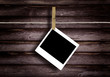 Old Polaroid Film Blanks Hanging on a Rope Held By Clothespins Old Polaroid Film Blanks Hanging on a Rope Held By Clothespins