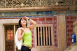 asian young woman looking around at the heritage site