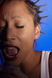 young woman singing with passion in microphone