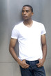 Photo of a fine black male posing against a metal structure