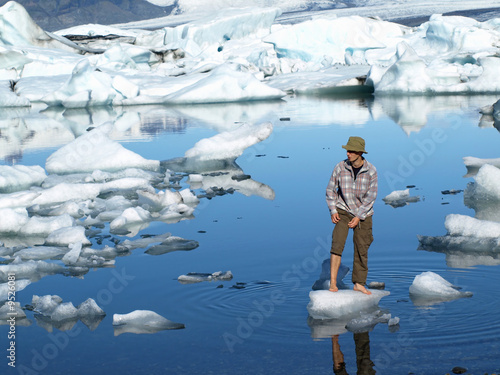 Photo: Man, standing barefoot on ice in Jokulsarlon lagoon, Iceland Man, standing barefoot on ice in Jokulsarlon lagoon, Iceland