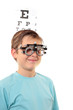 A boy with trial frames during a visit to the eye doctor