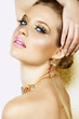 Beautiful blond woman with long lashes and colourful stones