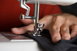 Hands work a sewing machine