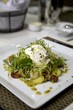 Poached egg salad on frisee with lardons
