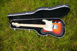 Guitar in case on grass Guitar in case on grass