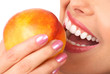 Beautiful young woman eating a peach. Isolated over white. Beautiful young woman eating a peach. Isolated over white.