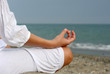 Photo: A woman is meditating by the sea A woman is meditating by the sea