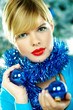 Beautiful young woman next to christmas tree