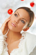 20-25 years old beautiful woman next to christmas tree
