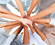Business people overlapping hands to show unity Business people overlapping hands to show unity