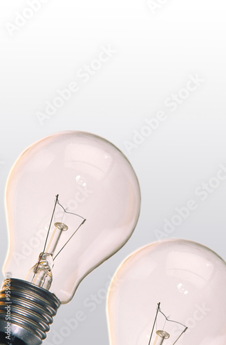 Photo: One electric lamp on smooth surface on grey background One electric lamp on smooth surface on grey background