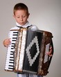 Young boy playing a 48 base accordion