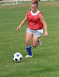 Youth Teen Soccer Player Chasing Ball Down Field Youth Teen Soccer Player Chasing Ball Down Field