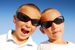 Outdoor portrait of two caucasian boys in  sunglasses