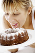 Foto: woman ready to bite into a cake woman ready to bite into a cake