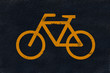Yellow bicycle marking on black fresh asphalt pavement Yellow bicycle marking on black fresh asphalt pavement