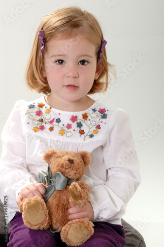 Photo: cute two year old blonde toddler poses with teddy cute two year old blonde toddler poses with teddy