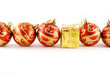 A few red balls and one gold gift on the white background