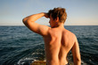 young  man on  background of  dark blue sky