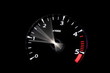 moving revs meter of a sports car on a black background.