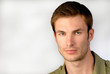 portrait  young serious businessman, looks in  chamber