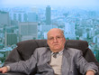 Portrait of an old businessman in front of the office window