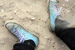blue sneakers on sandy beach