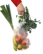 hand of a woman holding a grocery-bag with vegetables