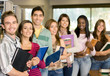 Casual group of college students smiling in the classroom.