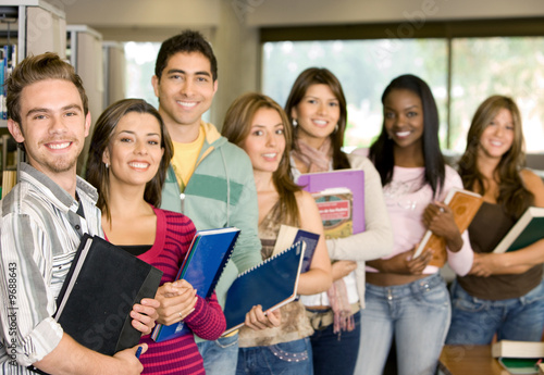 Photo: Casual group of college students smiling in the classroom. Casual group of college students smiling in the classroom.