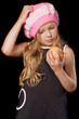 funny pensive little girl with apple in hands