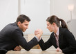 Photo: Co-workers aggressively arm wrestling for dominance Co-workers aggressively arm wrestling for dominance