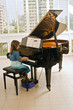 little girl playing the grand piano little girl playing the grand piano