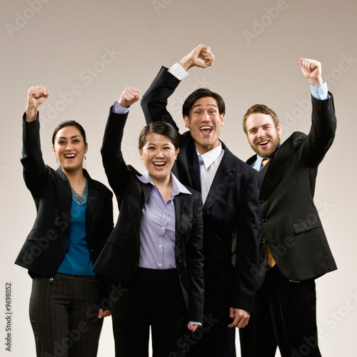 Photo: Excited co-workers cheering and celebrating their success Excited co-workers cheering and celebrating their success