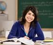 Student with text books doing homework in school classroom
