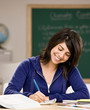 Student with text books doing homework in classroom