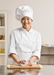 Photo : Chef in toque kneading dough in commercial kitchen Chef in toque kneading dough in commercial kitchen