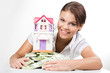 Portrait of lucky woman raking up heap of money
