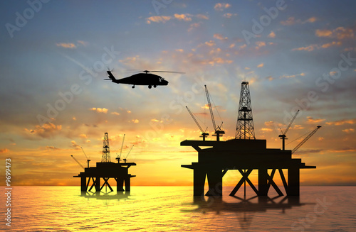 Illustration: Oil rig silhouette over orange sky Oil rig silhouette over orange sky