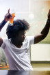 man dancing in a bar or a nightclub with a beer on his hand