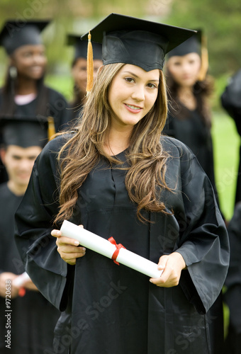 Foto: graduation girl holding her diploma with pride graduation girl holding her diploma with pride