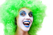 spooky female clown in heavy stage make-up