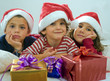 brothers and sister with presents the bed