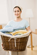 Housewife holding full basket of laundry